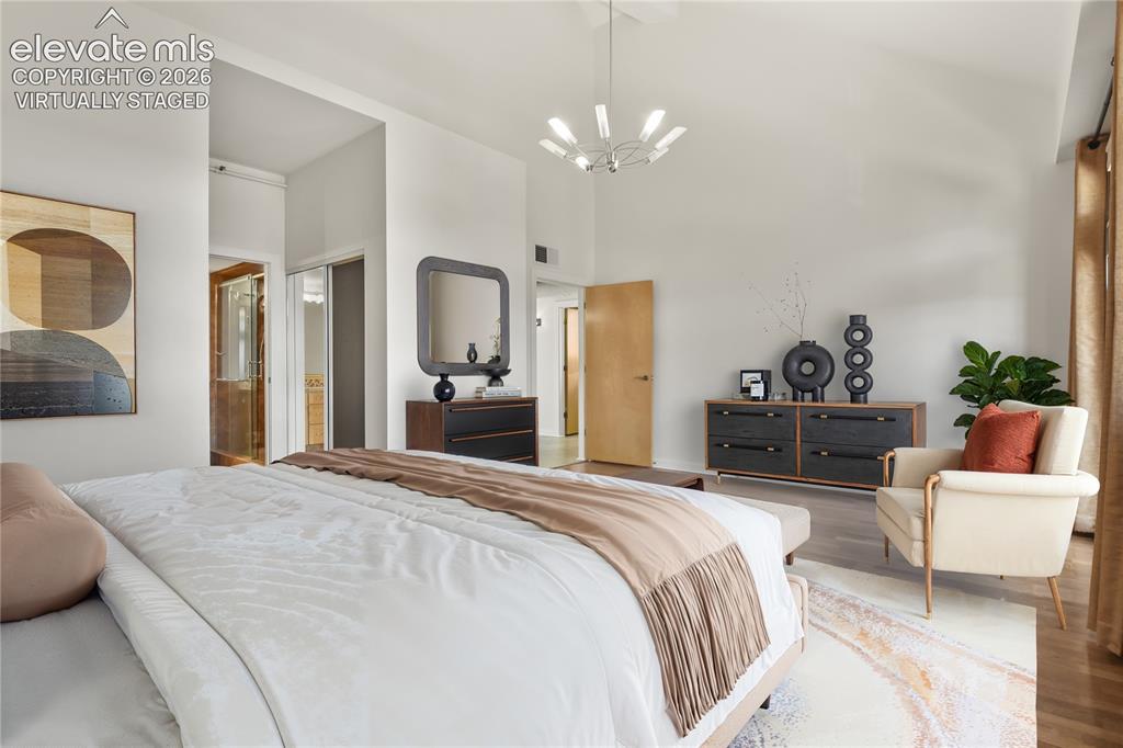 Image 13 of 50: Main level primary bedroom with dual walk-in closets and en-suite bath. Vir