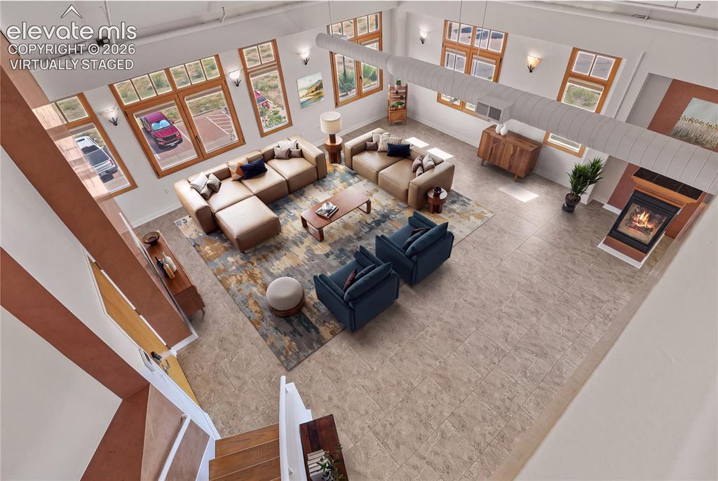 Image 22 of 50: View of the expansive great room from the upper loft space. Virtually Stage
