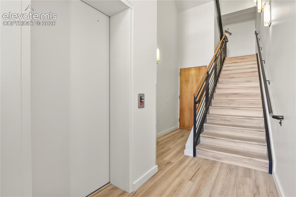 Image 30 of 50: Common area entry was just renovated with new paint, flooring, and lighting