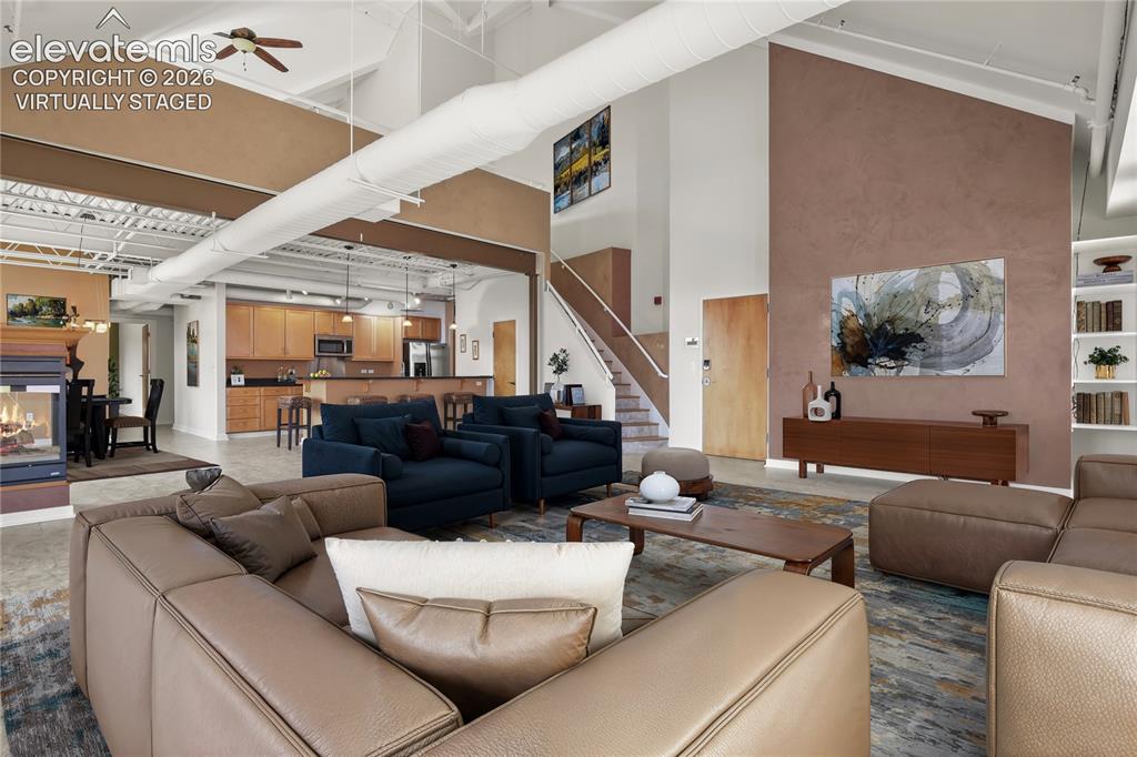 Image 5 of 50: Exposed steel beams, a striking three-sided gas fireplace, & custom Venetia