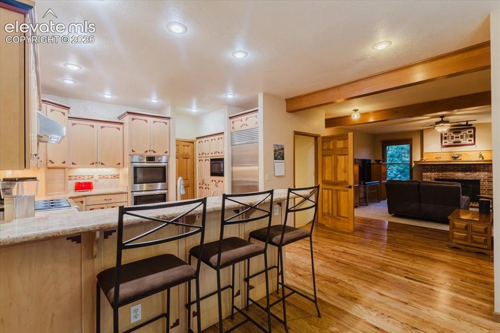 Image 14 of 50: Kitchen featuring a built-in double oven, integrated refrigerator, and a co