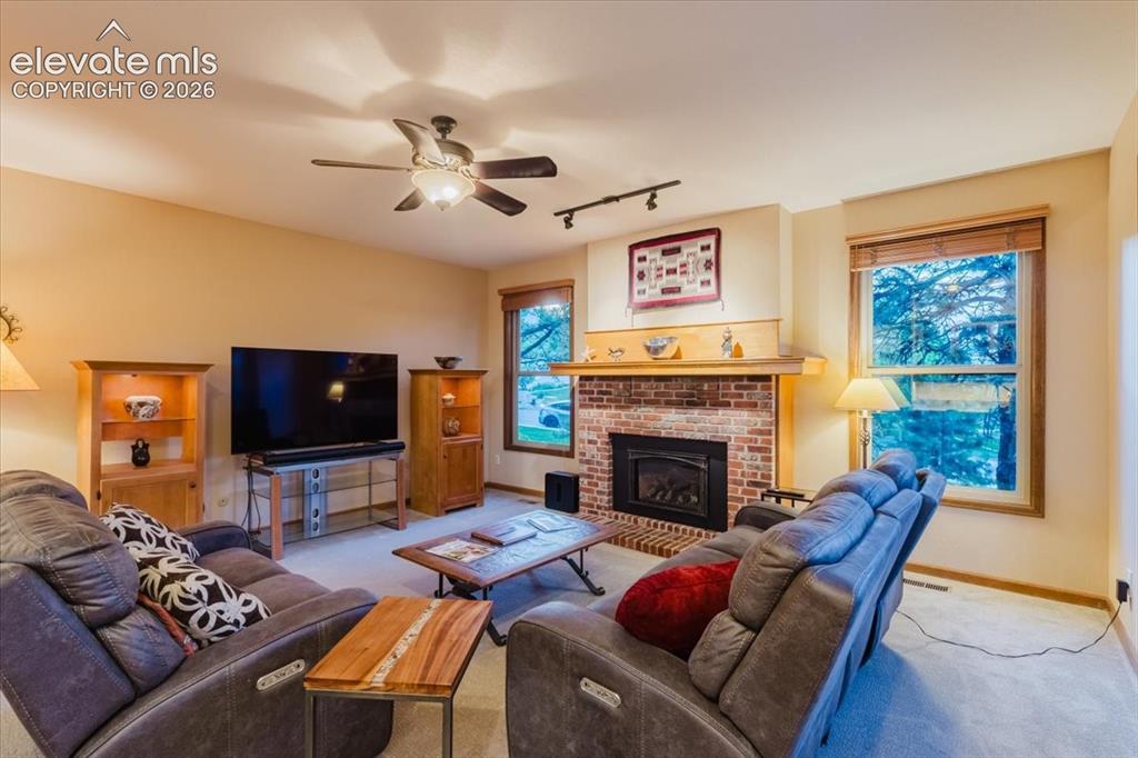 Image 20 of 50: Brick fireplace with a wood mantle and hearth
