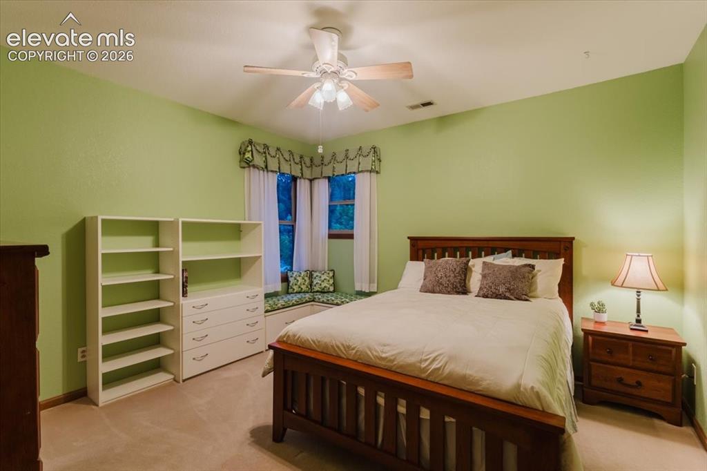 Image 31 of 50: Carpeted interior space featuring a ceiling fan with integrated lighting, a