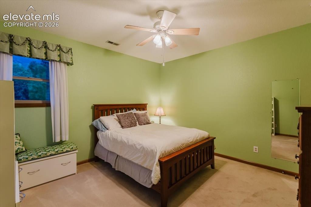 Image 32 of 50: Room featuring a ceiling fan with integrated lighting, a window with a vala