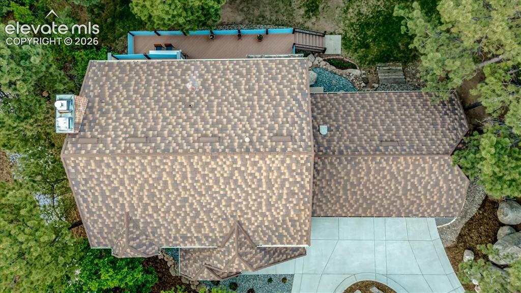 Image 40 of 50: stone coated steel roofing with varied tones, multiple rooflines, a multi-