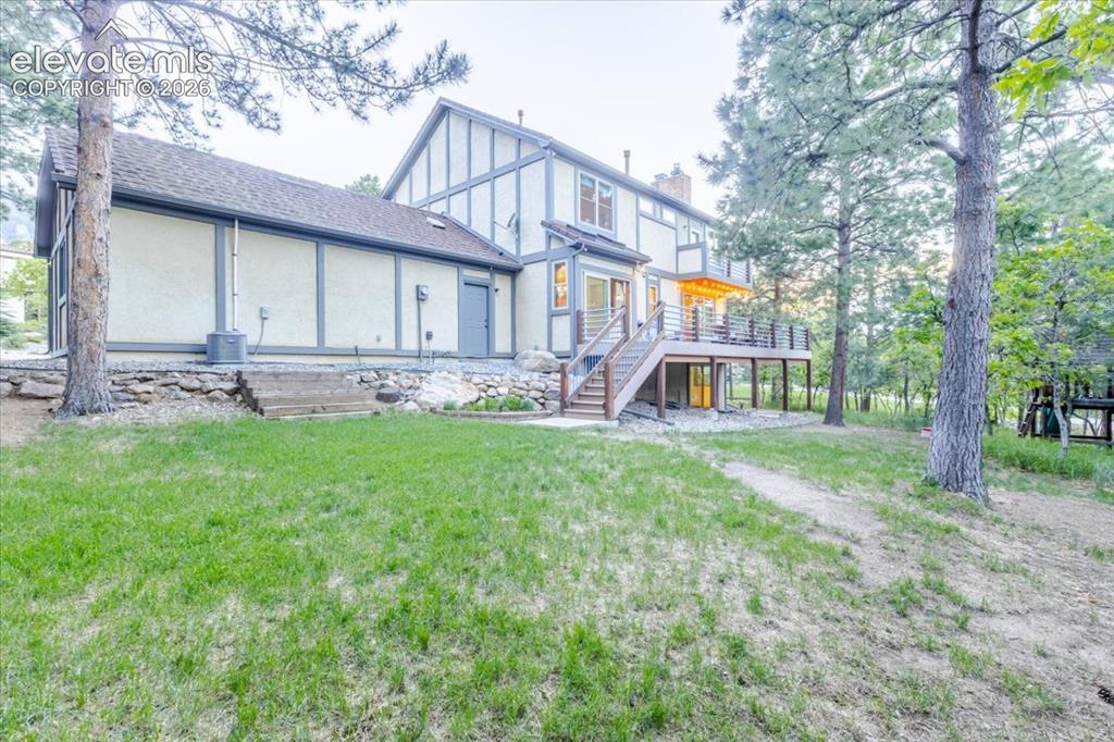 Image 43 of 50: Expansive rear exterior featuring a multi-level deck with metal railings an