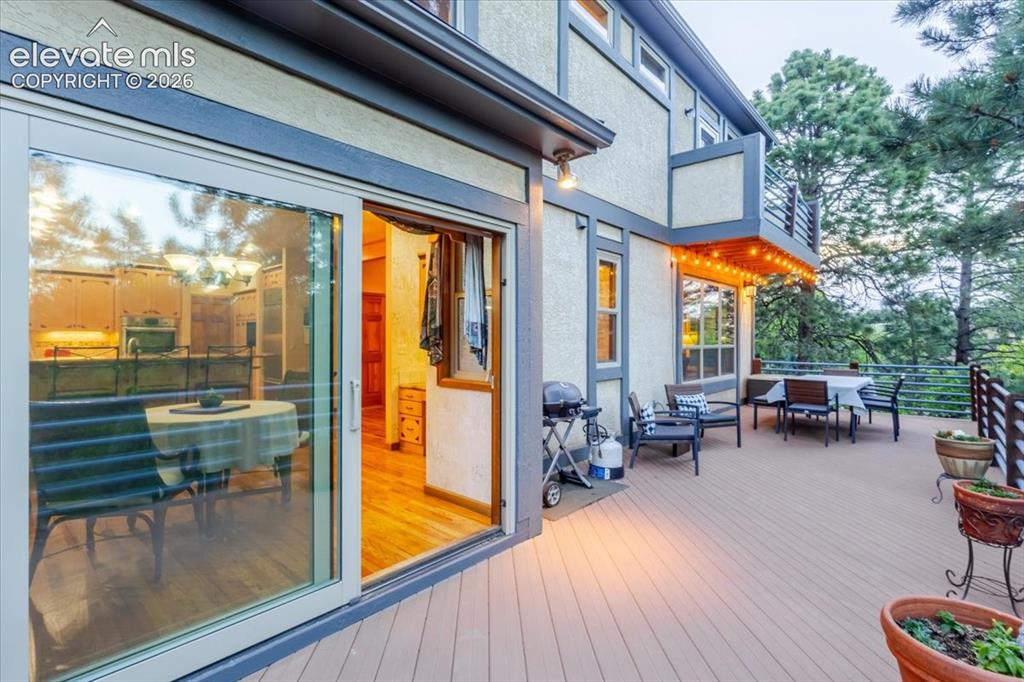 Image 44 of 50: Expansive exterior deck featuring composite decking, modern cable railings,