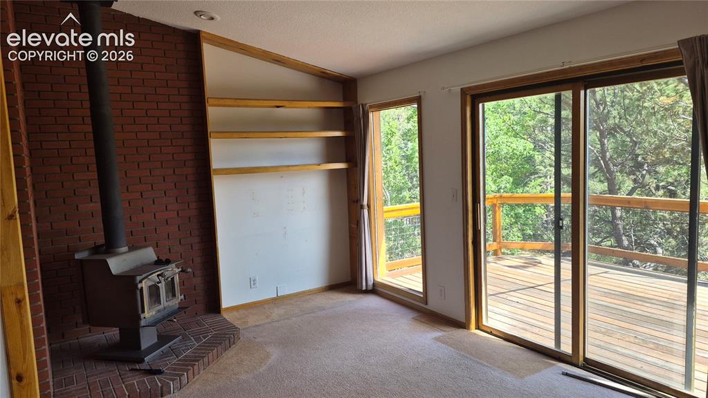 Image 5 of 6: Living room looking on to back deck