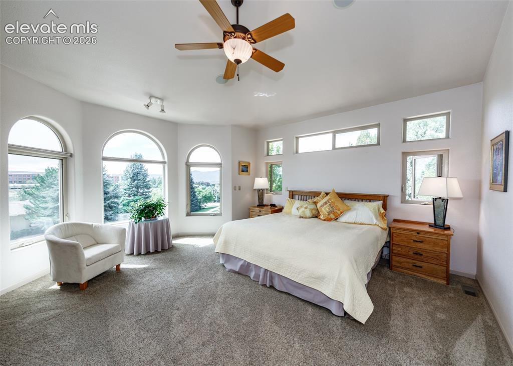 Image 11 of 43: Room with arched windows, additional transom windows, ceiling fan, recessed