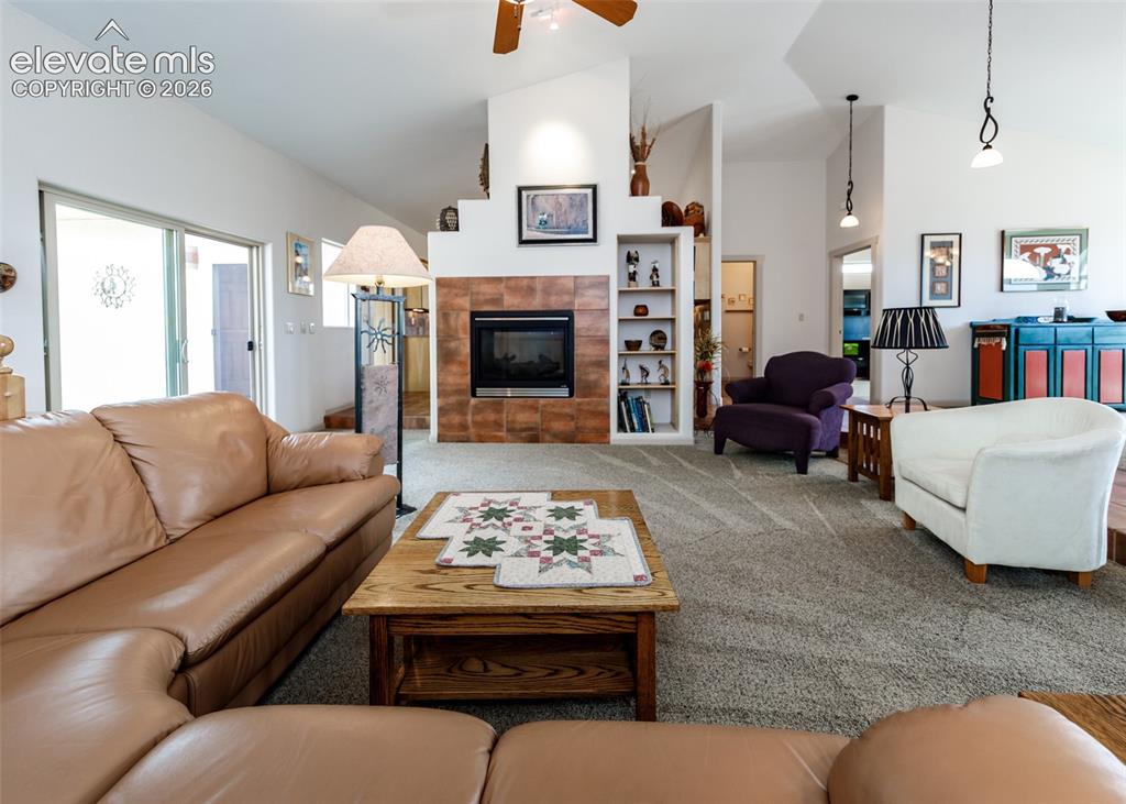 Image 20 of 50: Living room also offers a dual side fireplace with a tiled surround and int