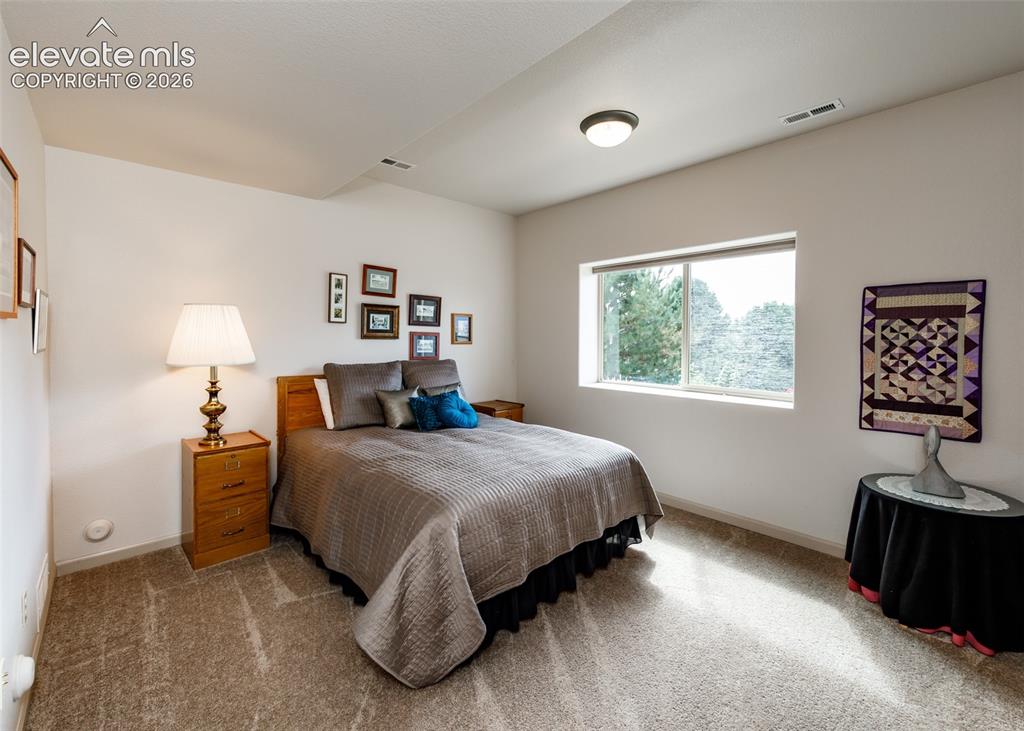 Image 30 of 50: Recessed lighting, wood-finish flooring, and a large window