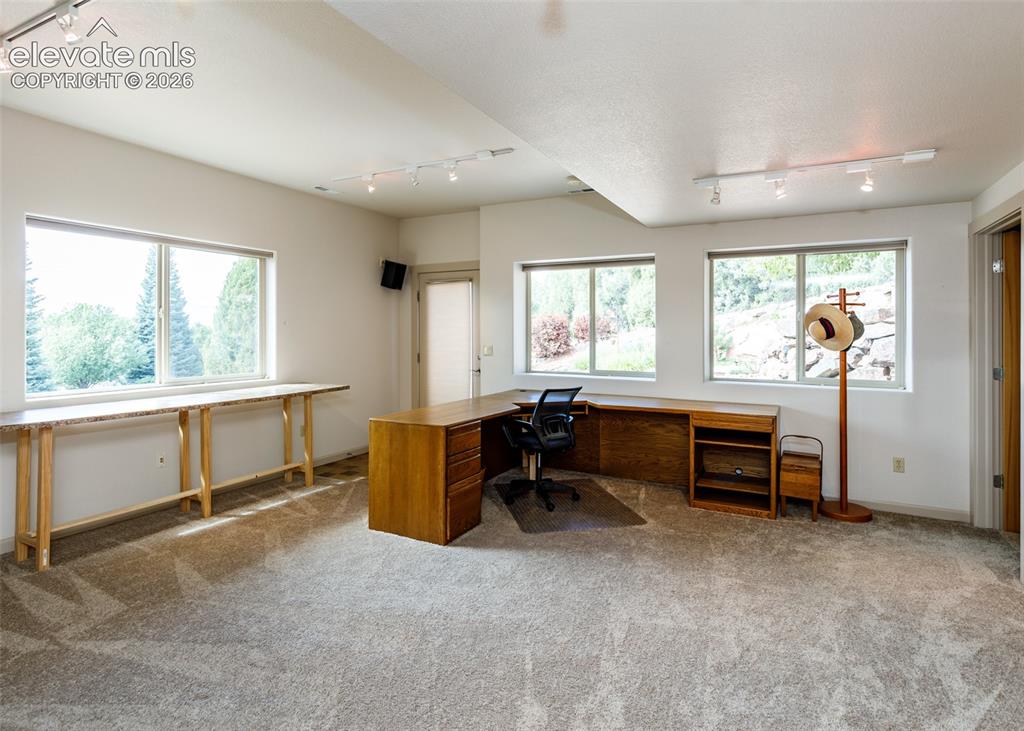 Image 38 of 50: Versatile area in lower level family room is perfect for crafts, office or 
