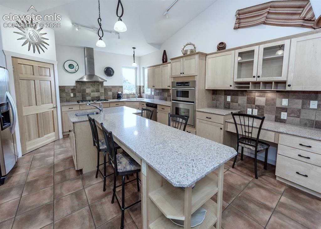 Image 4 of 43: Spacious kitchen, large island, granite countertops and stainless KitchenAi