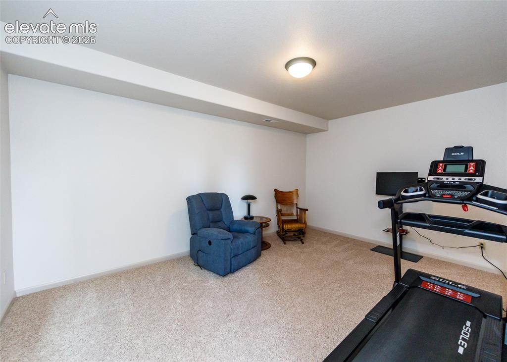 Image 40 of 50: Carpeted room with white walls, recessed ceiling beam, and a flush-mount ce