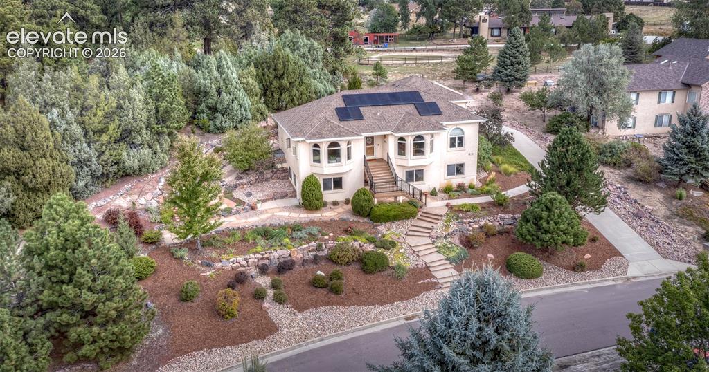 Image 44 of 50: This very stately home offers beautiful landscaping, paver walkways, trees 