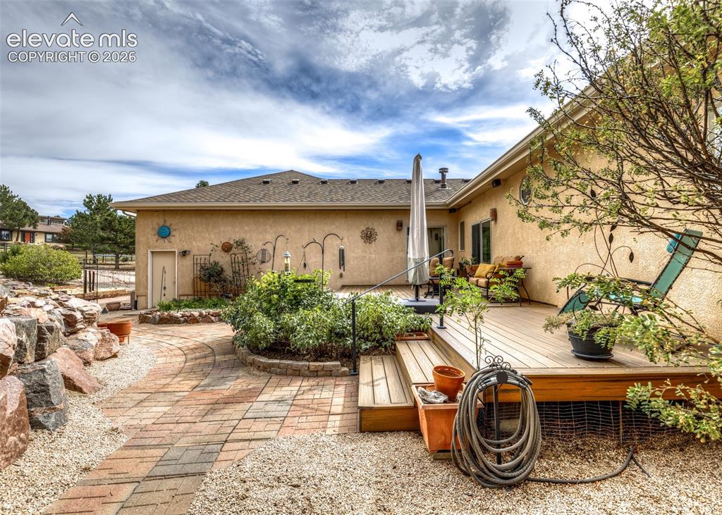 Image 47 of 50: Private backyard sanctuary offers a spacious Trex deck, water feature, matu
