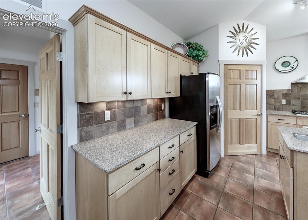 Image 7 of 50: Large corner pantry with multiple shelves, and beautiful upgraded cabinetry