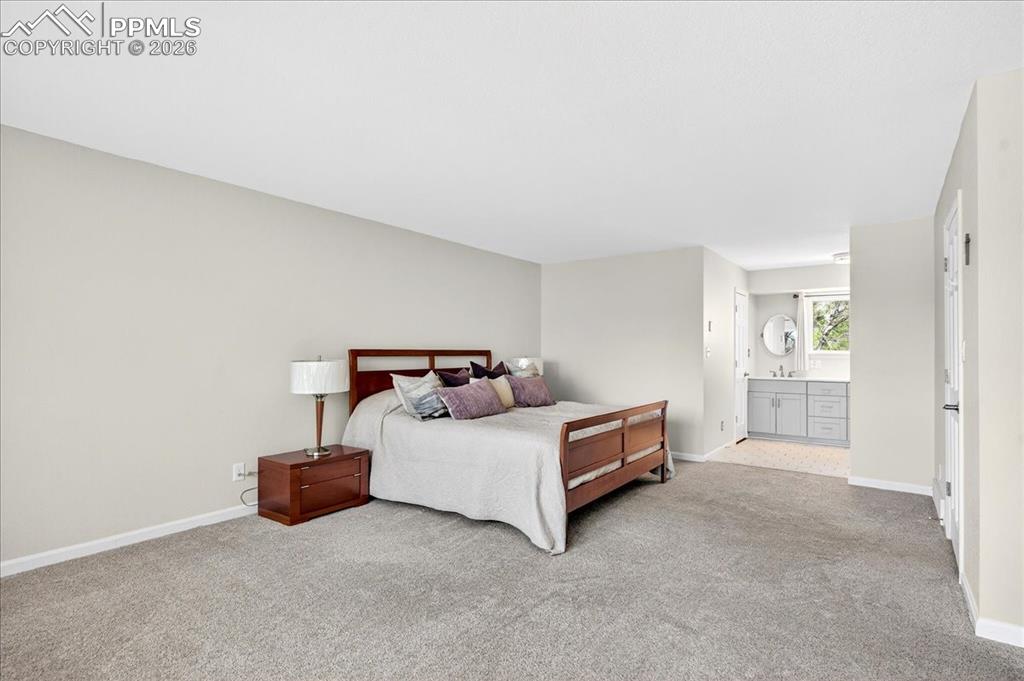 Image 18 of 48: Bedroom with ensuite bath and light carpet