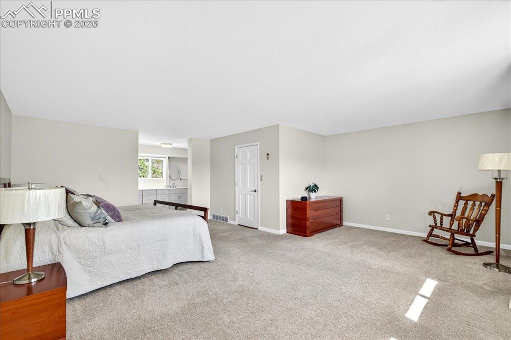 Image 19 of 48: Bedroom with carpet floors and baseboards