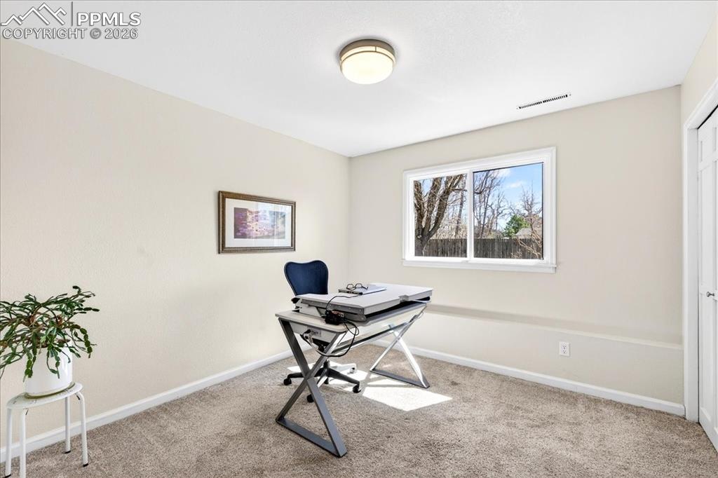 Image 26 of 48: Office area featuring baseboards and light colored carpet