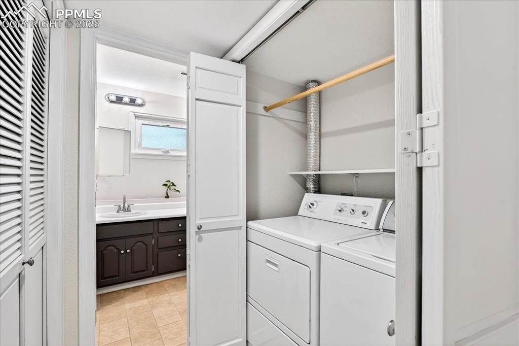 Image 30 of 48: Laundry area featuring washing machine and dryer