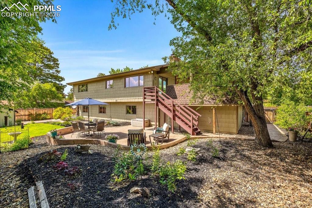 Image 40 of 48: Rear view of property with a patio area, a fenced backyard, and outdoor din