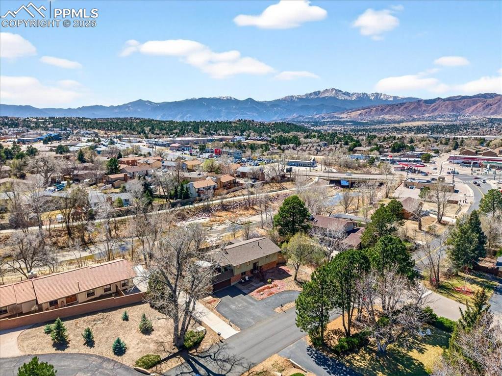 Image 47 of 48: Aerial view of residential area with a mountain backdrop