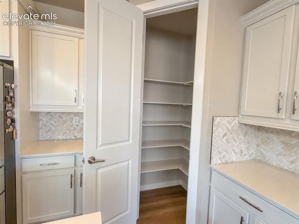 Image 19 of 50: Large and Spacious Quartz Kitchen Island in Gourmet Kitchen.