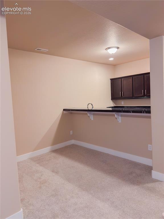 Image 38 of 50: Virtually Staged Basement Dining Area/wet bar
