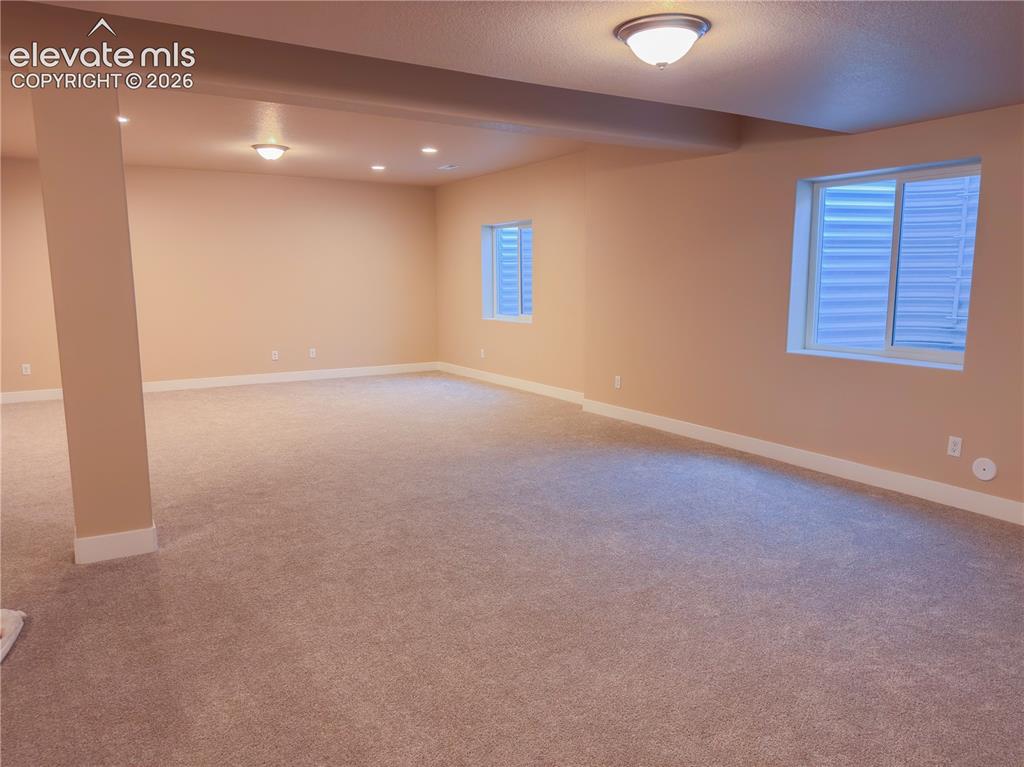 Image 40 of 50: Virtually Staged basement recreational room