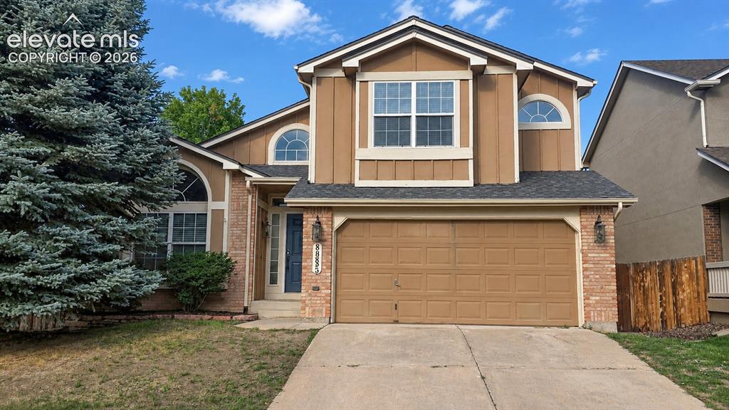 Image 1 of 25: Two-story residence featuring a two-car garage, brick accents, arched windo