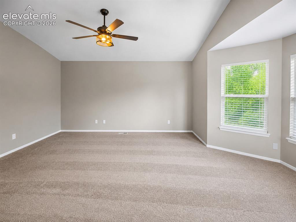 Image 10 of 25: Vaulted ceiling, ceiling fan with integrated lighting, carpeted flooring, m