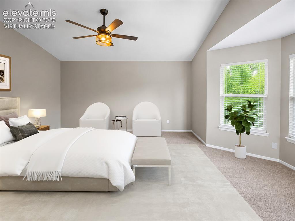 Image 9 of 25: Vaulted ceiling with a ceiling fan, bay window, and carpeted flooring - vir