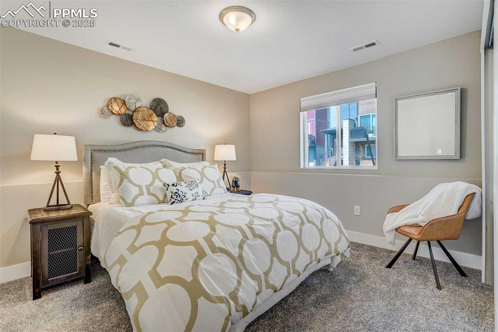 Image 34 of 42: Carpeted bedroom featuring baseboards