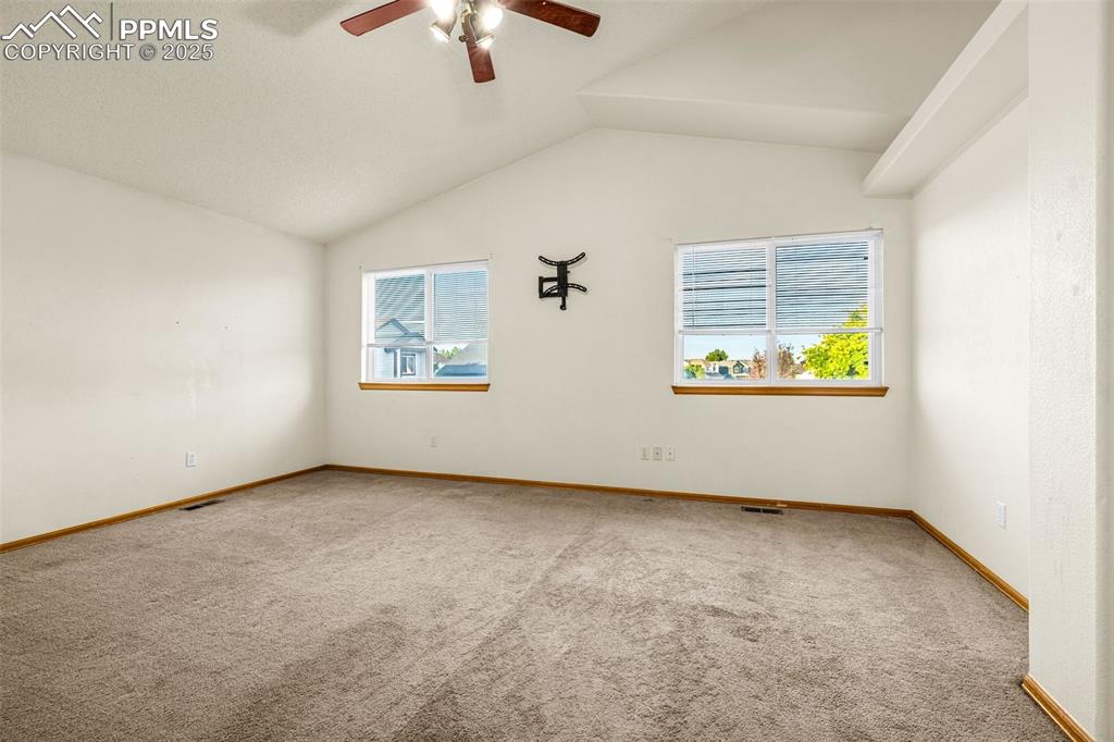 Image 18 of 40: Carpeted empty room featuring healthy amount of natural light, a ceiling fa