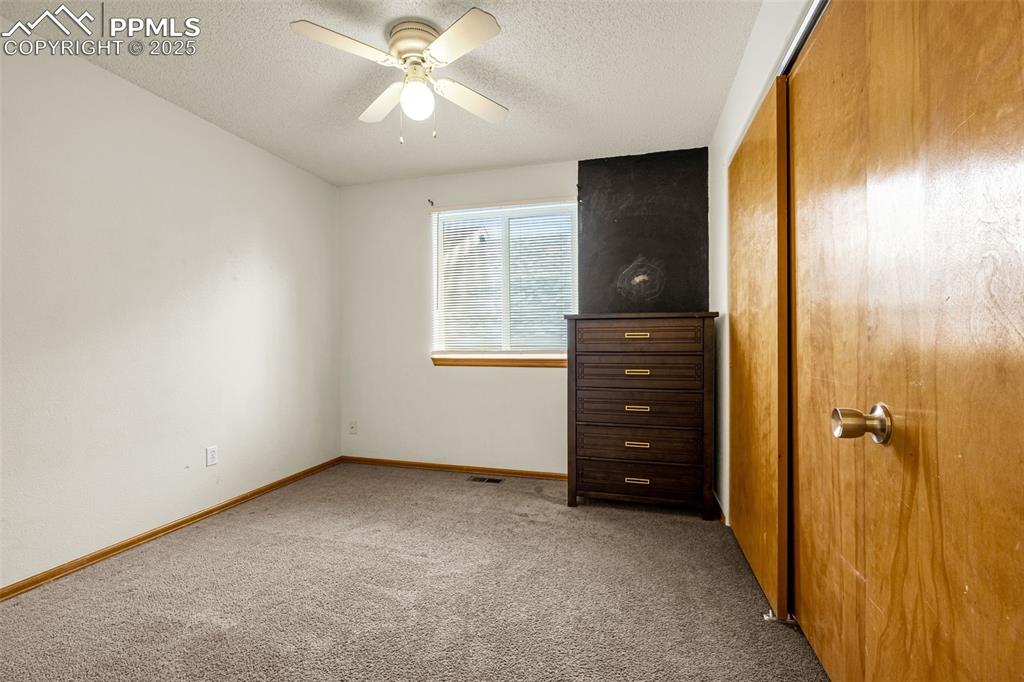 Image 21 of 40: Unfurnished bedroom with carpet, a textured ceiling, a closet, and ceiling 