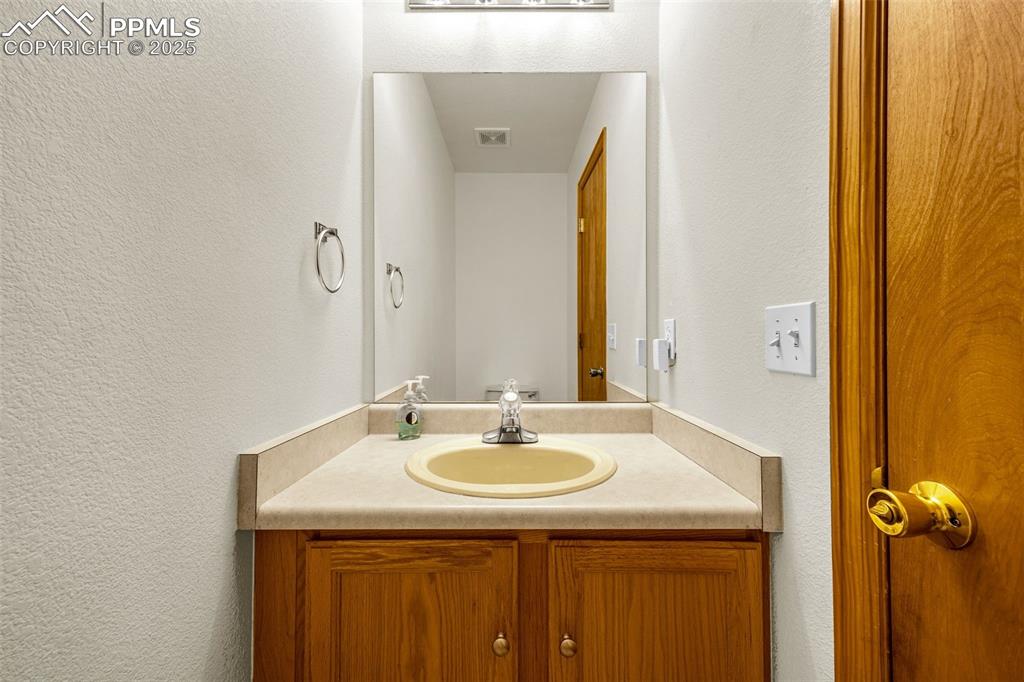 Image 23 of 40: Bathroom featuring vanity and a textured wall