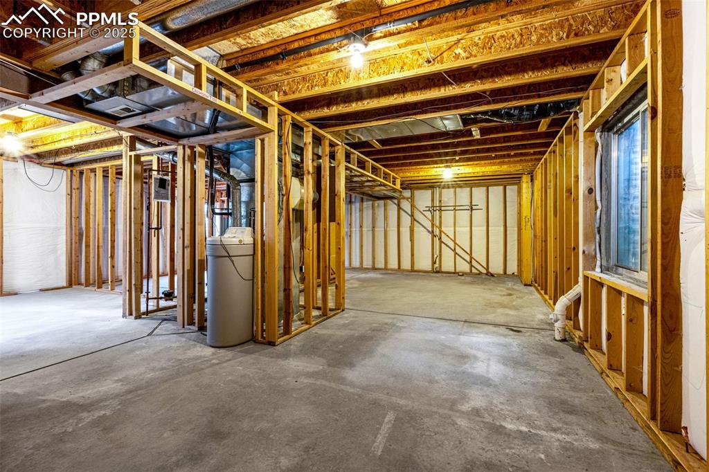 Image 28 of 40: Unfinished basement featuring a water softener system
