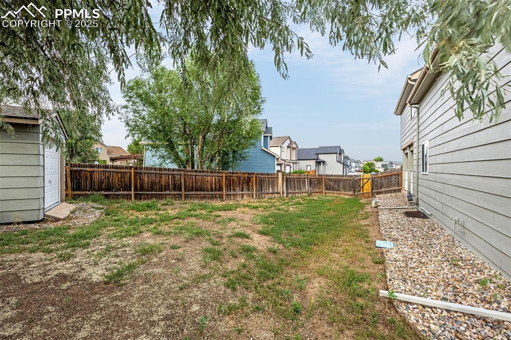 Image 34 of 40: Fenced backyard featuring a residential view