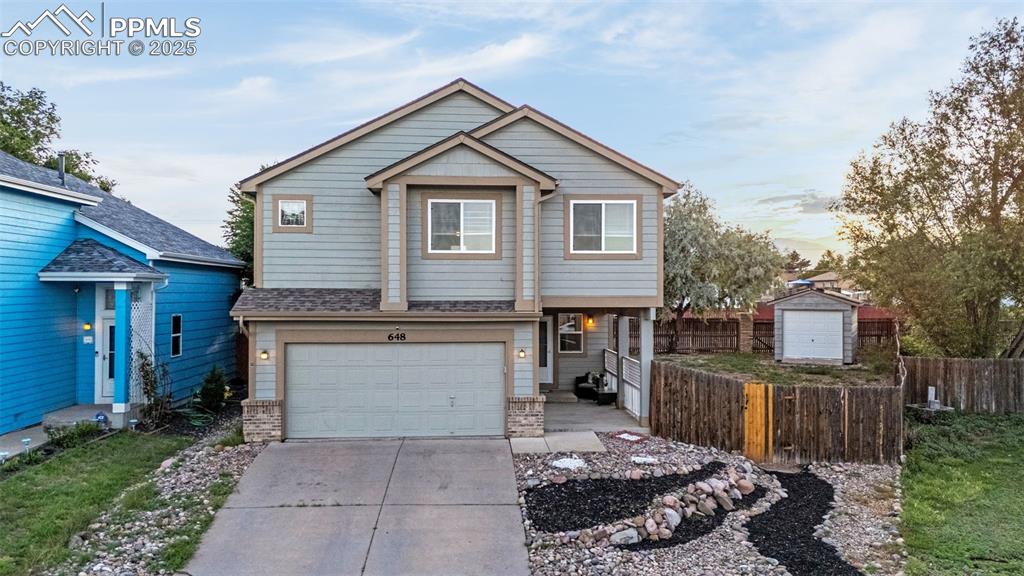 Image 39 of 40: View of front of property with driveway and an attached garage