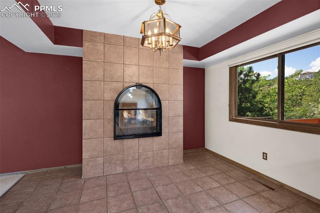 Image 17 of 47: custom gas fireplace insert in dining area