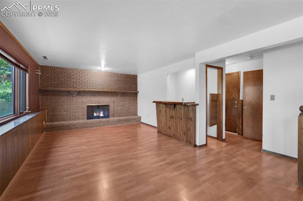 Image 25 of 47: lower level with wood burning fireplace and wet bar