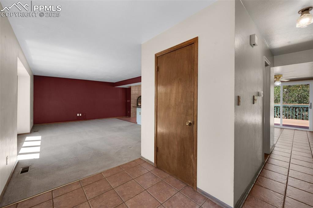 Image 8 of 47: front entry, opening in to living room