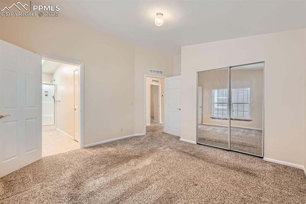 Image 15 of 28: Unfurnished bedroom with carpet and a closet