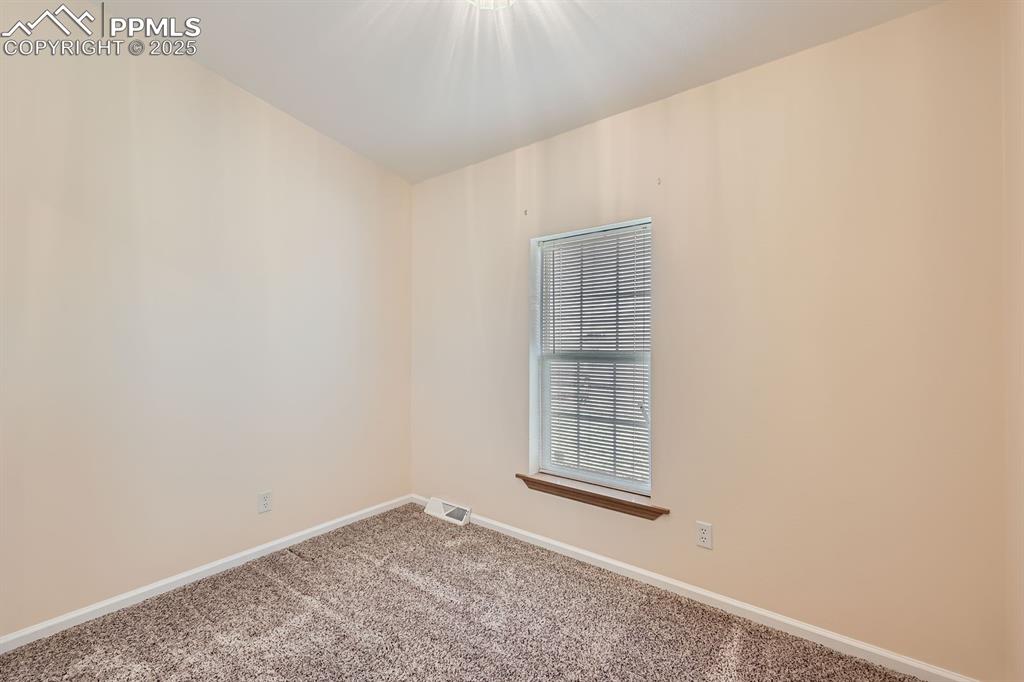 Image 18 of 28: Carpeted spare room with baseboards