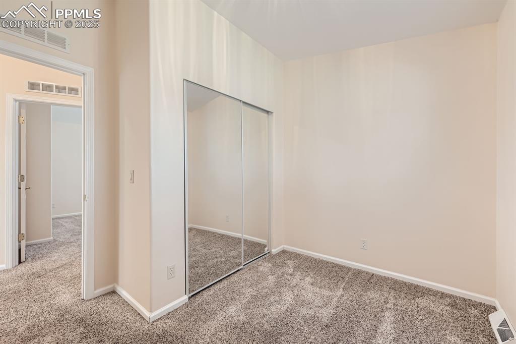 Image 19 of 28: Unfurnished bedroom with carpet flooring and a closet