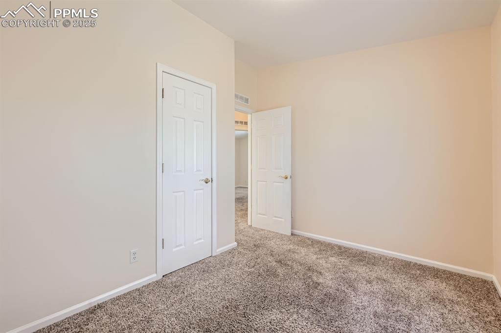 Image 21 of 28: Unfurnished bedroom featuring baseboards and carpet floors