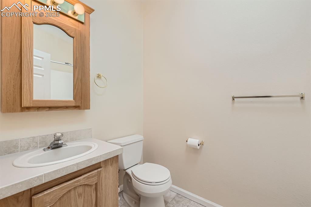 Image 22 of 28: Half bath with toilet and vanity