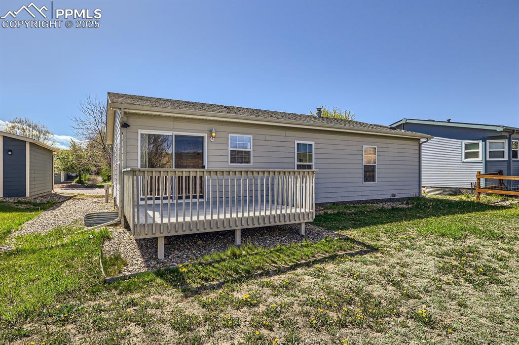 Image 28 of 28: Rear view of property with a deck and a yard