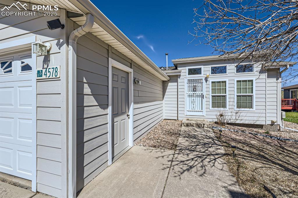 Image 3 of 28: View of side of property with a garage
